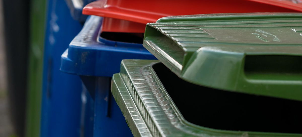 Coloured recycling bins lined up ready for collection