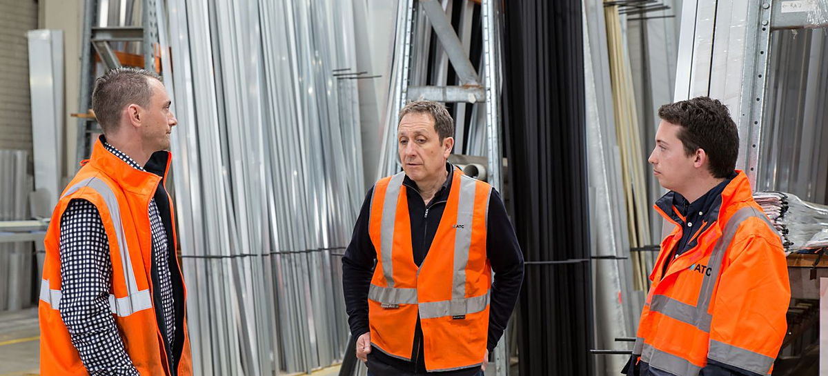 Warehouse team in high-visibility vests coordinating work