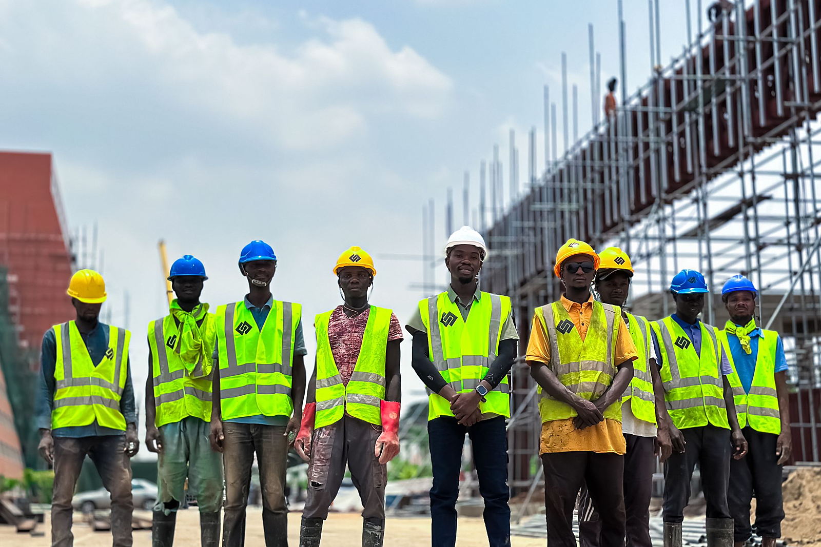 Crew of certified workers in hard hats and high-visibility vests